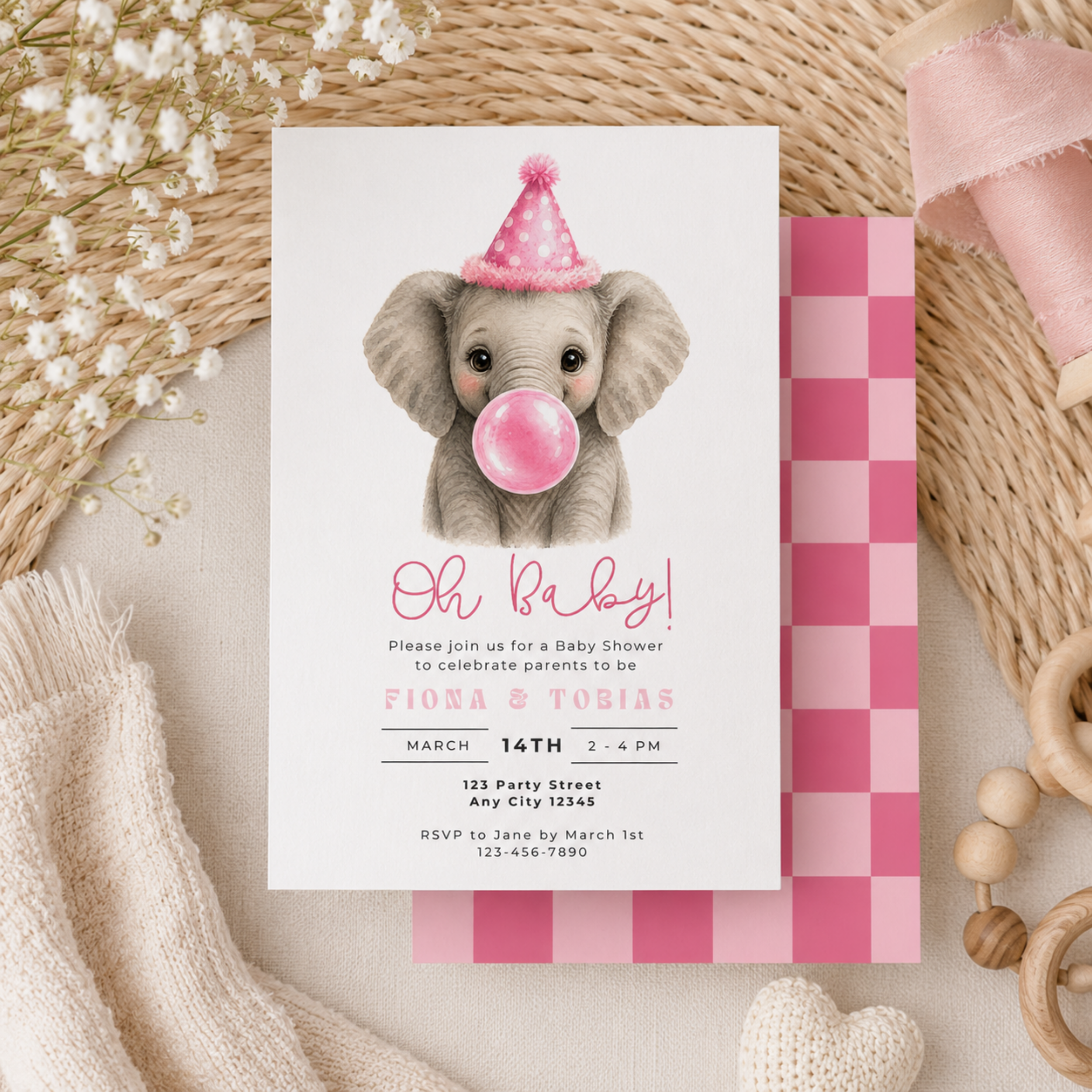 Baby shower invitation with an elephant wearing a pink party hat and blowing a pink bubble, surrounded by decorative items.